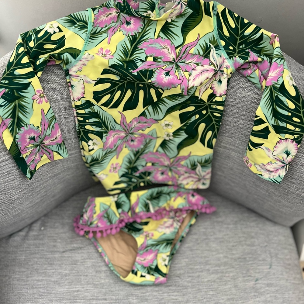 2 piece bathing suit. Never warn. 
Back has a zipper; long-sleeve top